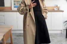 06 a minimalist look with a black turtleneck, an A-line midi skirt, black hiking boots, a tan coat for winter