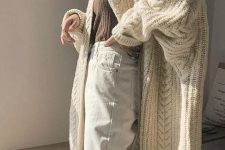 08 a neutral and cozy winter look with a taupe turtleneck, white jeans, a chunky patterned creamy cardigan of midi length