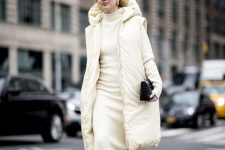 10 a dreamy neutral look with a creamy midi dress, a matching puffer coat, snakeskin print boots and a black bag