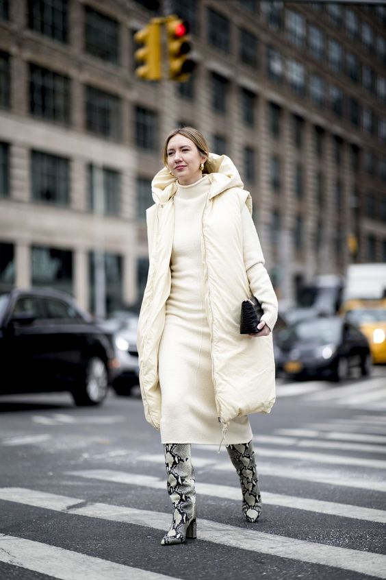 a dreamy neutral look with a creamy midi dress, a matching puffer coat, snakeskin print boots and a black bag
