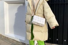 11 a sporty winter outfit with a creamy hoodie, a matching puffer coat, neon green sweatpants, white trainers and a bag