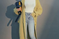 11 a white turtleneck, light blue jeans, burgundy ankle boots, a mustard long cardigan and a two-colored bag