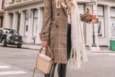 13 a winter look with a hoodie, leather leggings, combat boots, a plaid coat and a tan bag plus a white scarf