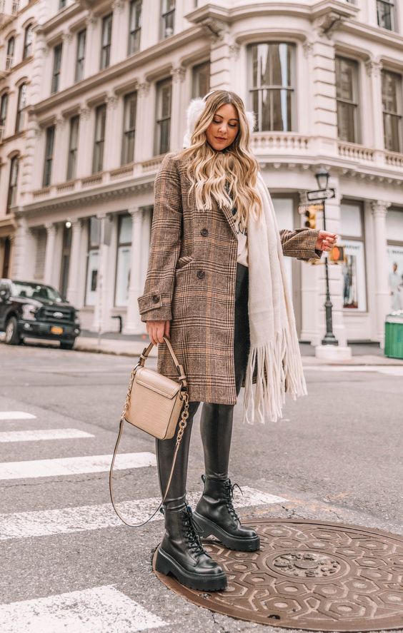 a winter look with a hoodie, leather leggings, combat boots, a plaid coat and a tan bag plus a white scarf