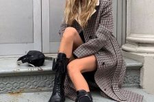 14 a stylish and classic plaid coat paired with massive black combat boots and a small black bag