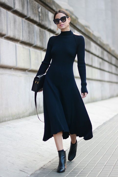 a black A line midi sweater dress, booties and socks, a black bag and statement earrings for work or a date