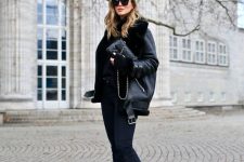 15 a total black look with a sweater, skinnies, combat boots, shearling coat and a small bag