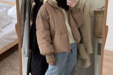 16 a sport chic winter look with a white hoodie, light blue jeans, white sneakers, a tan puffer jacket and a grey beanie
