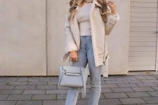 17 a neutral winter look with a turtleneck, light blue jeans, white combat boots and a shearling coat and a grey bag