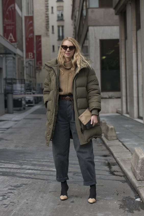 a pretty and cozy winter outfit with a tan turtleneck, graphite grey jeans, two tone boots, a matte green puffer coat