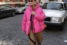 18 a catchy winter look with rust trousers, white and black Chelsea boots, a hot pink puffer jacket