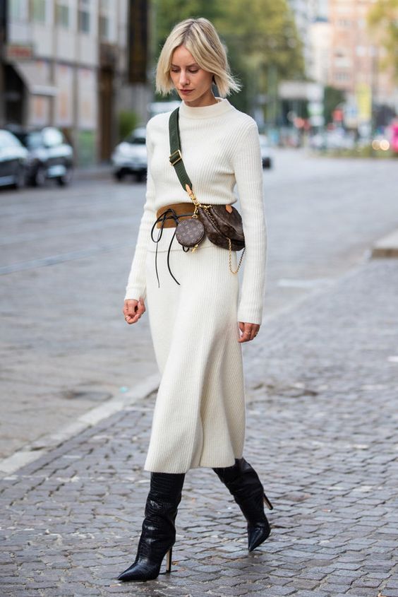 a refined look with a creamy midi knit dress, a brown belt, a brown printed mini bag, black wide knee boots
