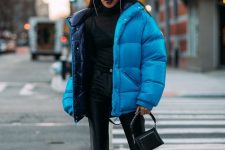 a trendy black outfit with a colorful puffer jacket