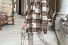 20 a neutral winter look with a tan hoodie, grey leather leggings, matching boots, a grey bag and a plaid shirt jacket