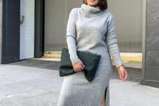 21 a grey fitting sweater dress with side slits, white sneakers and a black oversized clutch