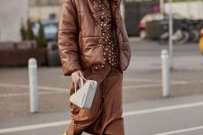24 a warm brown outfit with a rust polka dot shirt, a brown skirt, printed cowboy boots, a brown leather puffer jacket