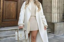 26 a neutral winter outfit with a tan knit suit – a turtleneck and a mini skirt, a creamy coat and a bag, white boots