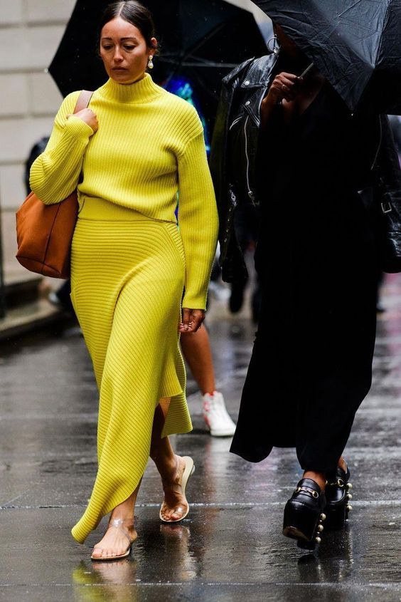 a jaw-dropping lemon yellow knit suit with a turtleneck and asymmetrical maxi skirt for a touch of bold color