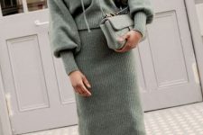28 a beautiful and comfy outfit with a knit green hoodie and a matching midi skirt, a matching green bag and brown boots