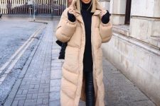 28 a bold contrasting outfit in black, with a tan puffer coat that refreshes the look and makes it more eye-catchy