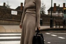 29 a winter work look with a grey turtleneck and a matching midi skirt, black hiking boots and a black bag