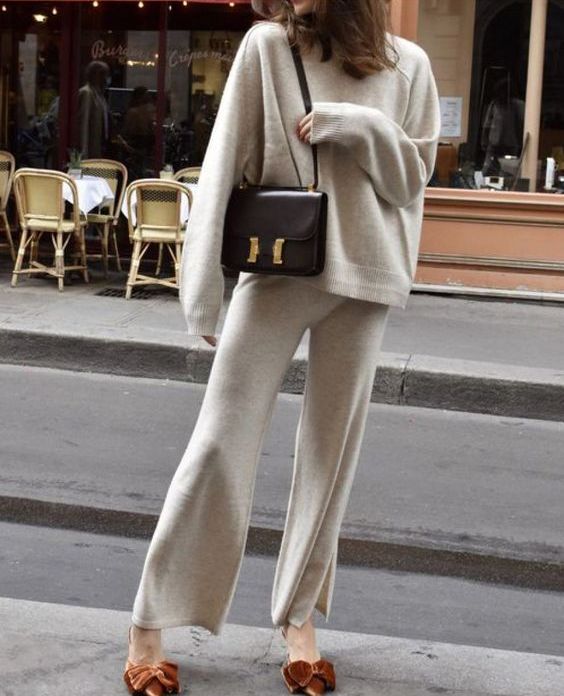 a lovely and comfortable look with a neutral knit suit, rust bow shoes, a black bag for every day