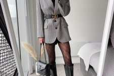 32 a black turtleneck, leather shorts, a grey printed blazer with a belt, black riding boots, a bag to rock in winter