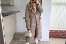 34 a chic winter outfit with a white turtleneck and jeans, a tan plaid midi coat, tan Chelsea boots and a creamy bag