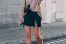 35 a tan jumper, a black slit mini skirt, white chunky Chelsea boots and a black mini bag