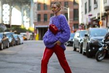 40 a bright look with a purple chunky patterned sweater, red leather trousers, red strap shoes and a bag