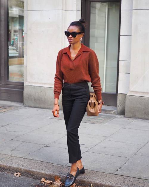 a burgundy polo knit, black tailored trousers, black loafers and a large tan bag plus catchy earrings