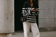 48 a black and white striped zip sweater, white jeans, two-tone shoes and a small black bag