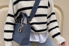 50 a lovely look with a white shirt, a cream and black striped sweater, light blue jeans and a blue bag