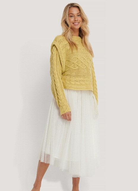 With airy white pleated midi skirt