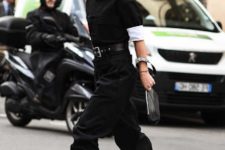 With black short sleeved sweater, white shirt, black jogger pants and black embellished belt