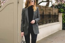 With black skinny pants, sunglasses, black suede heeled ankle boots and gray tote bag