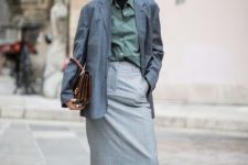 With button down shirt, brown bag, gray midi skirt and beige low heeled high boots