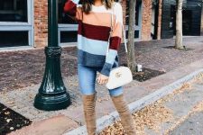 With color block sweater, skinny jeans and white bag