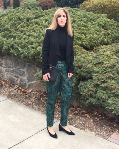 With emerald printed trousers, black leather clutch and black low heel shoes