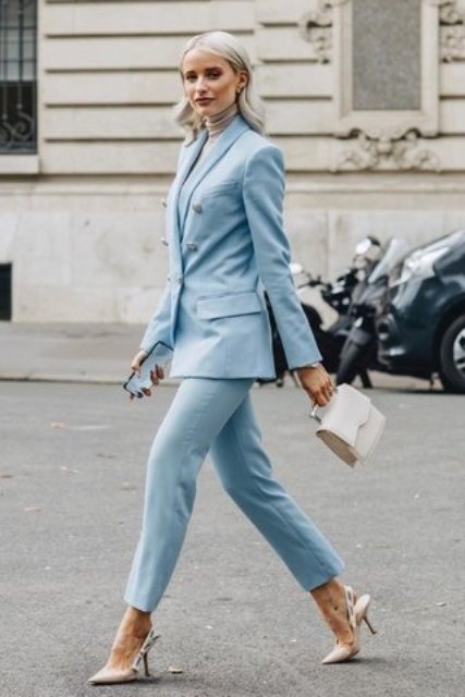 With light blue cropped trousers, white mini bag and beige high heels