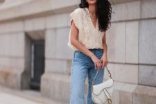 With light blue flare jeans, white bag and white sneakers