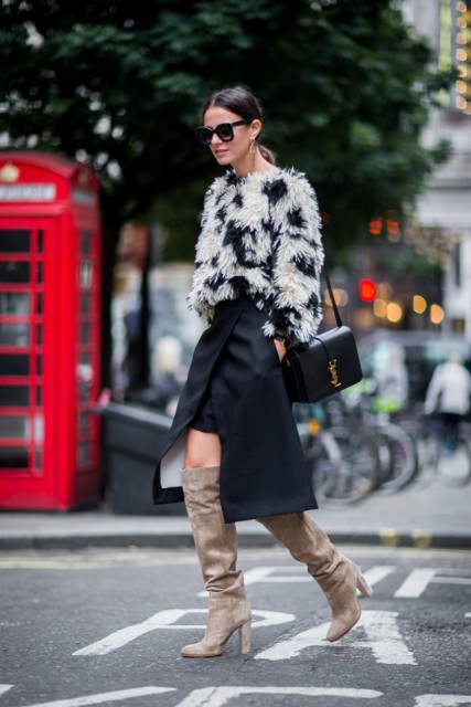 With navy blue and white faux fur jacket, asymmetrical skirt and black leather bag