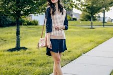 With navy blue shirtdress, brown tassel bag and white low heeled ankle boots