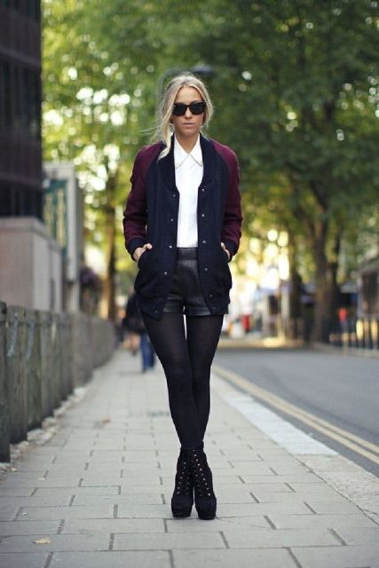 With white button down shirt, black leather shorts and navy blue and purple jacket
