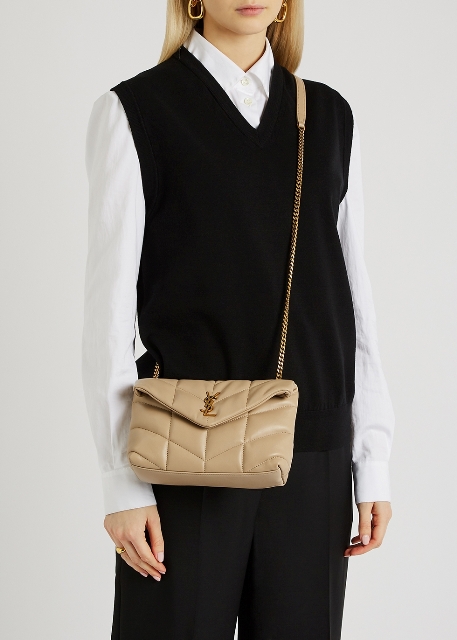 With white button down shirt, black sweater vest and black trousers