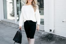With white loose sweater, black bag and black trousers