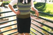 With white shirt, black skirt and beige and black shoes