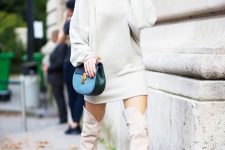 With white sweatshirt dress and blue chain strap bag