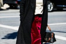 With white turtleneck, black midi coat, bag and colorful printed boots