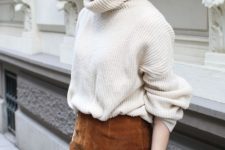 09 a trendy winter look with a creamy oversized jumper, a rust-colored suede A-line mini and layered bracelets
